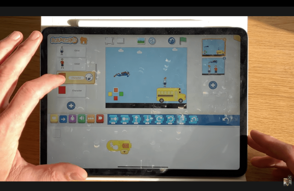 The block code for the orange joypad button in the ScratchJr Superman Game Project.